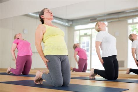 Group Of Active Mature Women Practicing Yoga Stock Photo Image Of