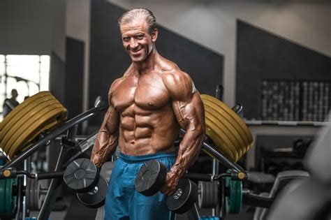 Premium Photo Brutal Aged Strong Bodybuilder Athletic Men Pumping Up