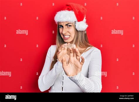 Beautiful Hispanic Woman Wearing Christmas Hat Disgusted Expression