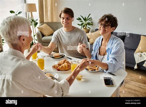 A Joyful Breakfast Gathering Features Lesbian Parents And Their Adult Son Sharing Love And