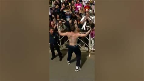 Shirtless Christian Braun Jumps From A Firetruck During The Denver