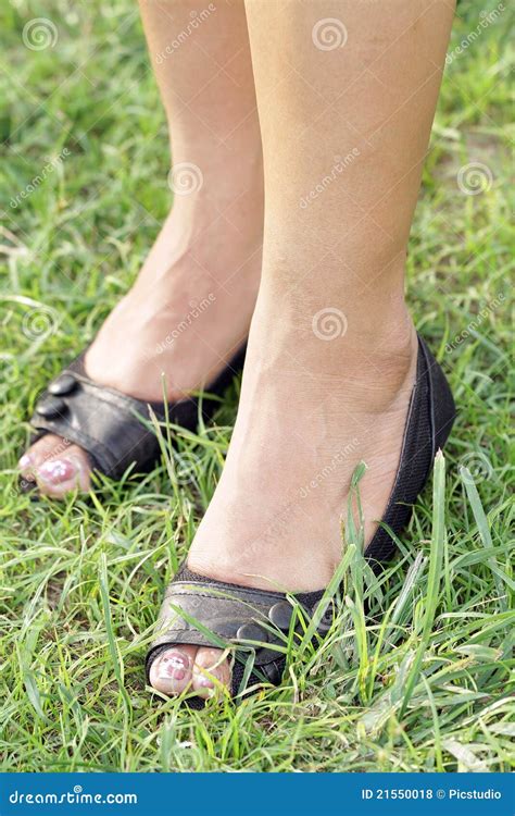 Women`s Feet In The Sand On The Beach Royalty Free Stock Image