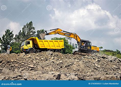 Excavator Of Jcb Company Digging And Filling A Tipper For Widenig Road