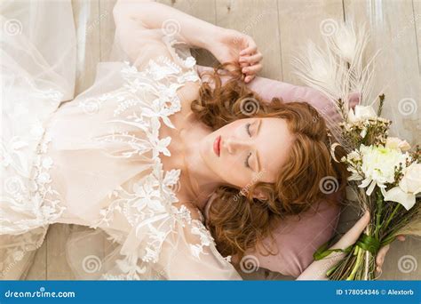 Beautiful Natural Redhead Girl Bride With Nude Makeup Wearing A White Dress Relaxed Lying On