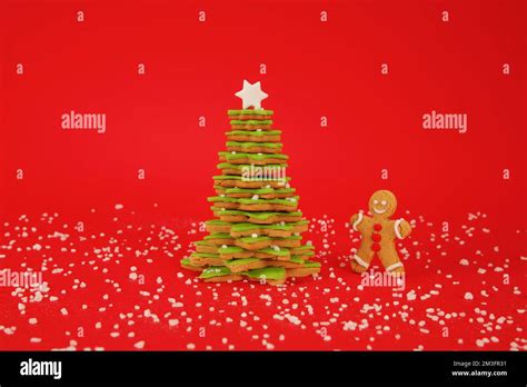 Christmas Tree And Cookie Man On Red Background Stock Photo Alamy