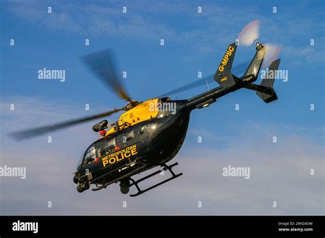 Metropolitan Police helicopter Eurocopter EC145 G-MPSC flying low. Eye in the sky. Searchlight ...