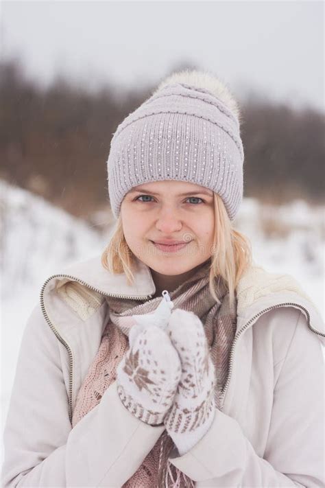 A Blonde Girl In Winter Clothes Walking On A Snowy Steppe Smiling Woman In Light Clothes In