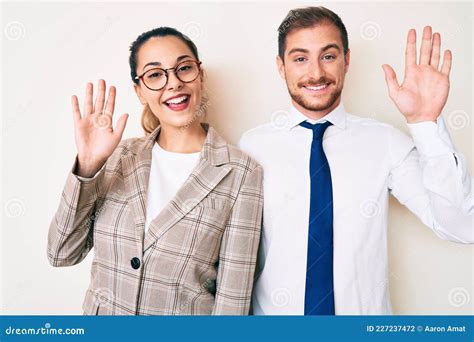 Beautiful Couple Wearing Business Clothes Waiving Saying Hello Happy