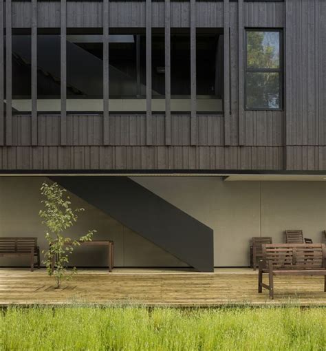 Two Wooden Benches Sitting Next To Each Other On A Grass Covered Field