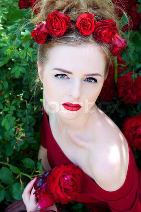 Lady Vamp In Crimson Red Dress With Naked Shoulders And Red Roses