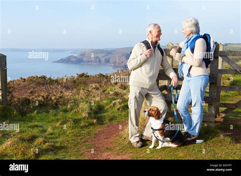 Senior Couple Walking Along Coastal Path Stock Photo Alamy