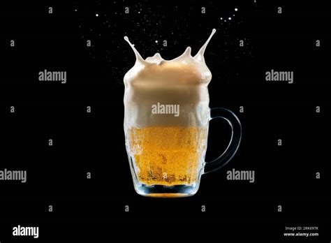 A Close Up Shot Of A Glass Of Beer With Liquid Being Poured Around The Rim Creating A Splash