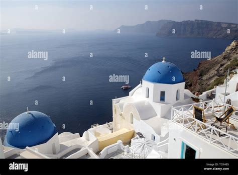 Church With Blue Roof Top In Oia And Overview Of The Caldera And