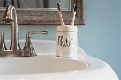 Closeup Of Bamboo And Charcoal Toothbrushes On The Bathroom Sink Stock