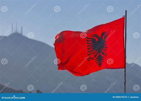 Albanian Flag Waving In Shkoder With Skadar Mountains Backdrop Stock