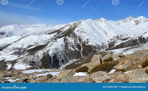 Snow Capped Mountains Rocks And Sparse Vegetation Beautiful View Of