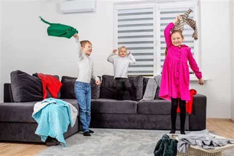 Three Children Are Having Fun In Room And Making Mess Happy Childhood