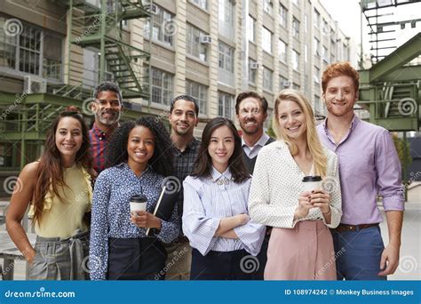 Portrait Of Eight Friendly Coworkers Outside Their Workplace Stock