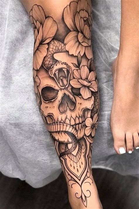 A Woman S Leg With Flowers And A Skull On The Bottom Half Of It