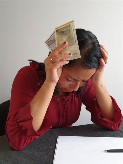 Brunette Woman With Expression Of Despair And Grabbing Danish Money