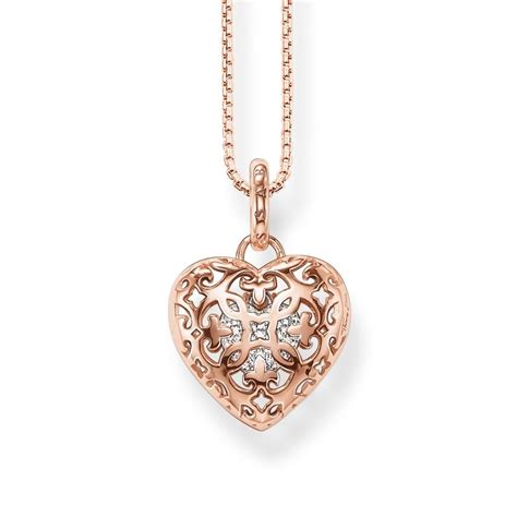 A Rose Gold Heart Pendant With Diamonds