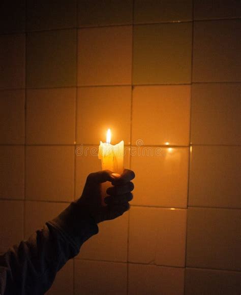 Hand Holding The Candle Against The Tiled Wall Stock Image Image Of