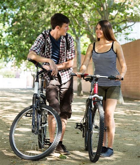 Couple Riding Bikes In The Park Stock Image Image Of Enjoying