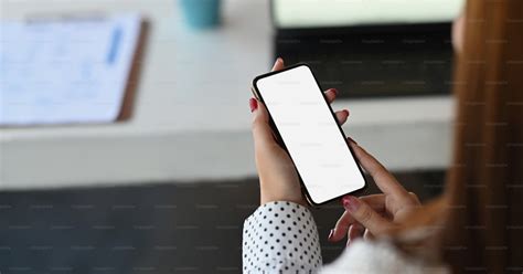 Image Of Woman Hands Are Holding Black Cell Phone With White Blank Screen Blank White Screen