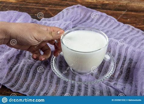 A Woman S Hand Is Holding A White Cup Of Hot Milk Drink With Cinnamon