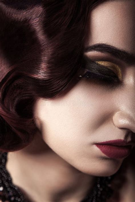 Portrait Of Beautiful Naked Fashion Model With Wavy Hair Style Hat And Dark Makeup On Red