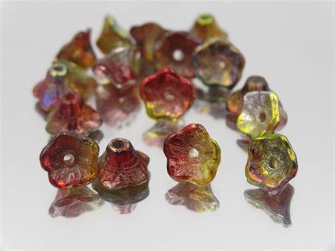 Many Different Colored Glass Beads On A White Surface