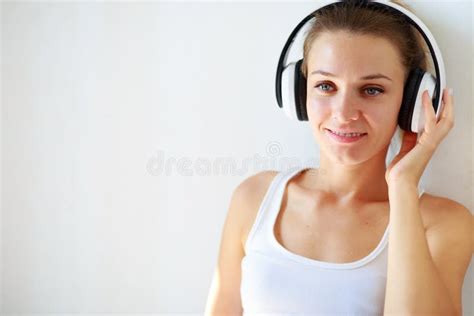 Beautiful Brunette Girl With Headphones Listening To Music While