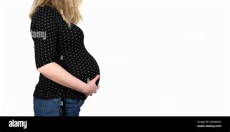 Side View Of Midsection Of 9 Months Pregnant Woman In Polka Dotted