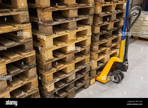 Hand Pallet Truck With Stack Of Wooden Pallets Warehouse Equipment