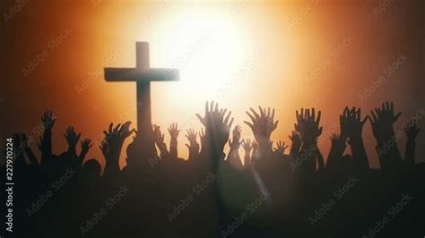 Silhouettes Of Hands Raised In Worship With Light Rays And Cross Vídeo