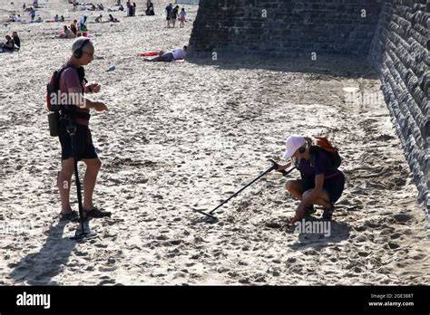 Metal Detectorists On Whitmore Bay Beach Barry Island South Wales