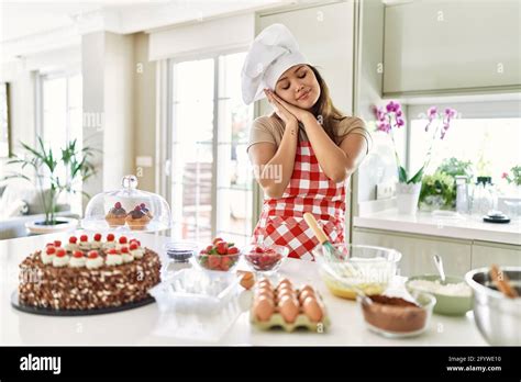 Beautiful Young Brunette Pastry Chef Woman Cooking Pastries At The Kitchen Sleeping Tired