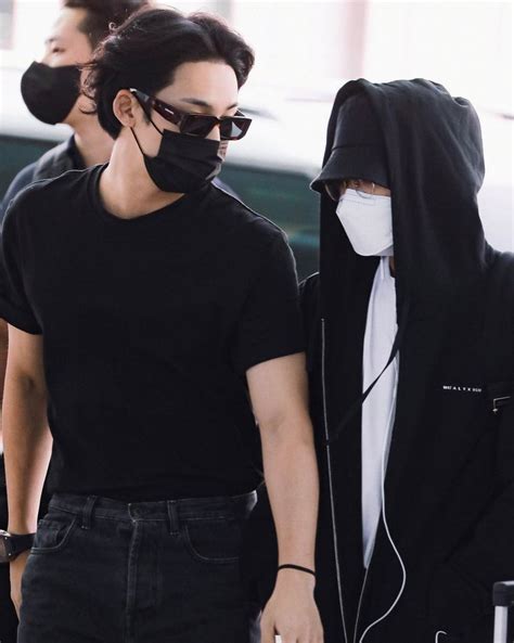 Two People Wearing Face Masks Walking Together