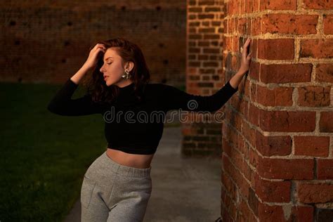 Portrait Of A Beautiful Sensual Redhead Girl Posing In Sunset Sunlight