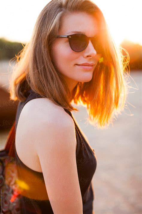 Sunlit Smiling Woman With Casual Hair And Sunglasses By Stocksy Contributor Alexandra Bergam