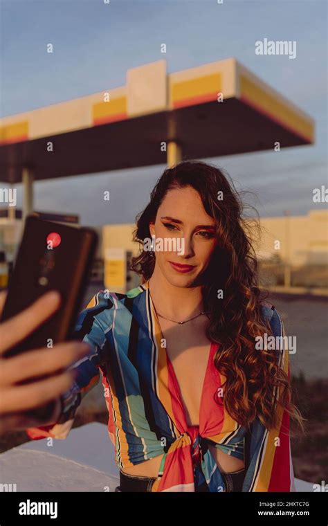 Closeup Of An Attractive Woman Taking A Selfie At A Gas Station Stock