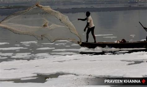 Chhath Devotees Fishermen Navigate Toxic Froth Over Yamuna India