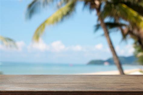 Premium Photo Wood Table Top And Blurred Summer Beach And Sky Background