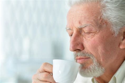 Premium Photo Portrait Of Smiling Senior Man Drinking Coffee