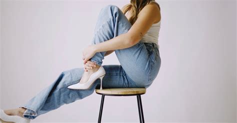 Woman In Jeans Sitting On Chair · Free Stock Photo