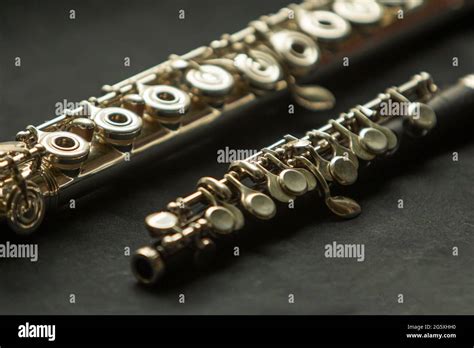 Musical wind instrument piccolo flute and brass flute Stock Photo - Alamy