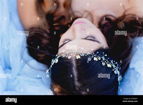 The Brunette Is Lying With Your Eyes Closed And Smiling The Decoration On The Hair Stock Photo