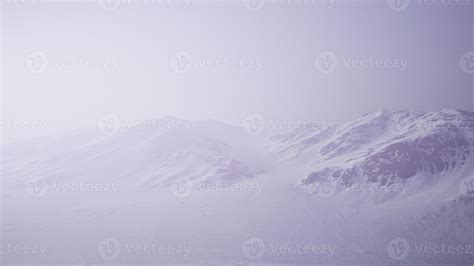 Aerial Landscape of snowy mountains and icy shores in Antarctica ...