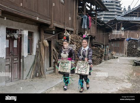 Dong Woman In Traditional Attire Walking In Huanggang Dong Village With