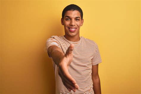 Young Handsome Arab Man Wearing Striped T Shirt Standing Over Isolated